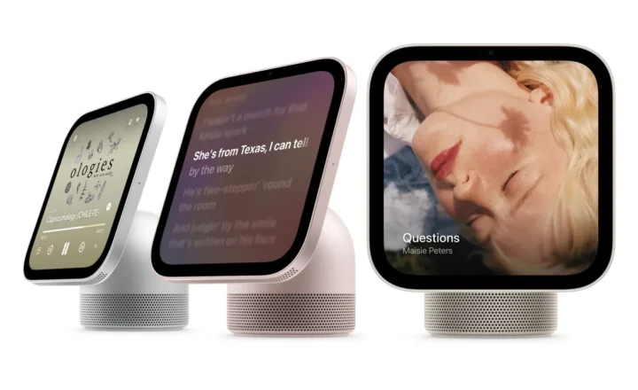 Three rounded-square smart displays on perforated speaker bases against a white background. Their screens show podcast playback controls, song lyrics, and cover art labeled “Questions” by Maisie Peters.
