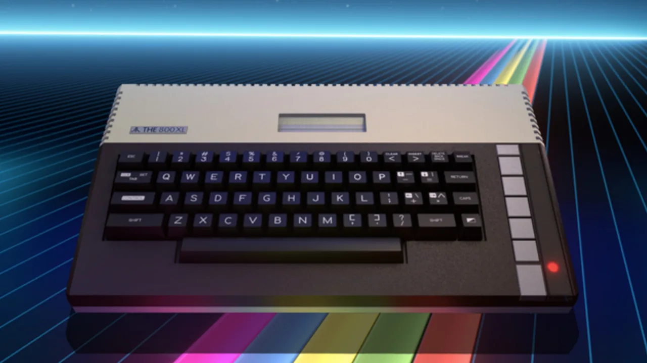 THE800XL computer with a cream upper casing, dark keyboard, vertical row of pale function buttons and glowing red indicator, shown against a blue neon grid with multicolored stripes.