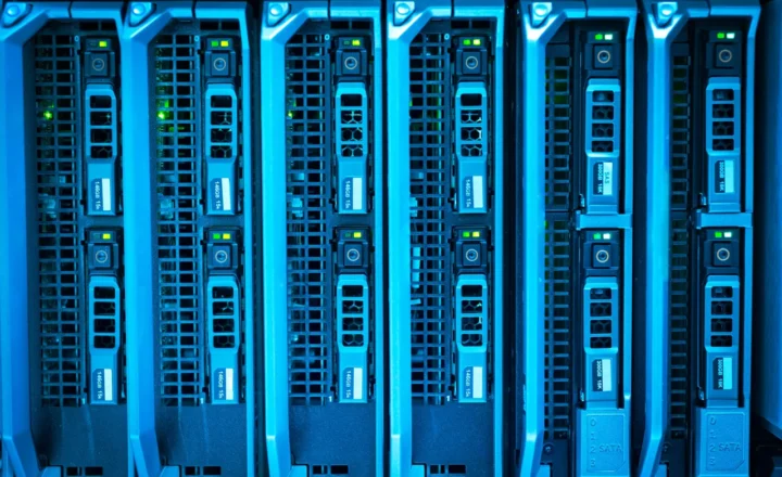 Blue-lit server racks with rows of storage drives and green indicator lights.